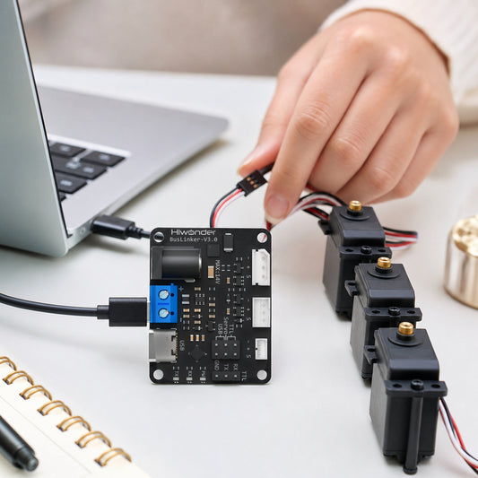 BusLinker V3.0 servo driver board – the board on a desk connected by USB-C to a laptop and by a 3-pin cable to a chain of three black bus servos