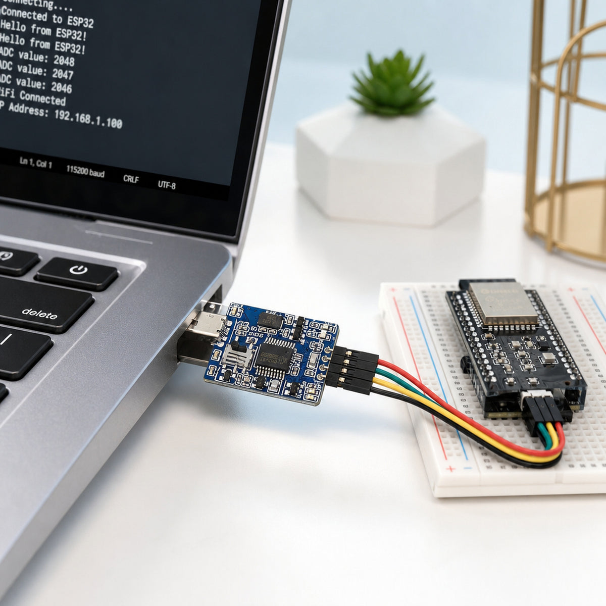 CH340 USB to UART adapter – the adapter plugged into a laptop USB port with four jumper wires running to an ESP32 module on a breadboard