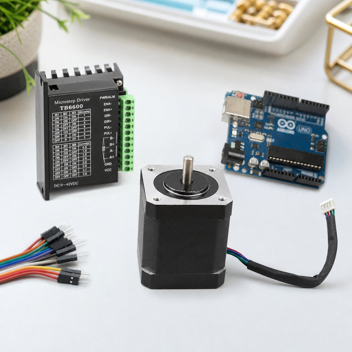 NEMA 17 stepper motor – top-down view of an electronics workbench: the stepper motor next to a TB6600 driver