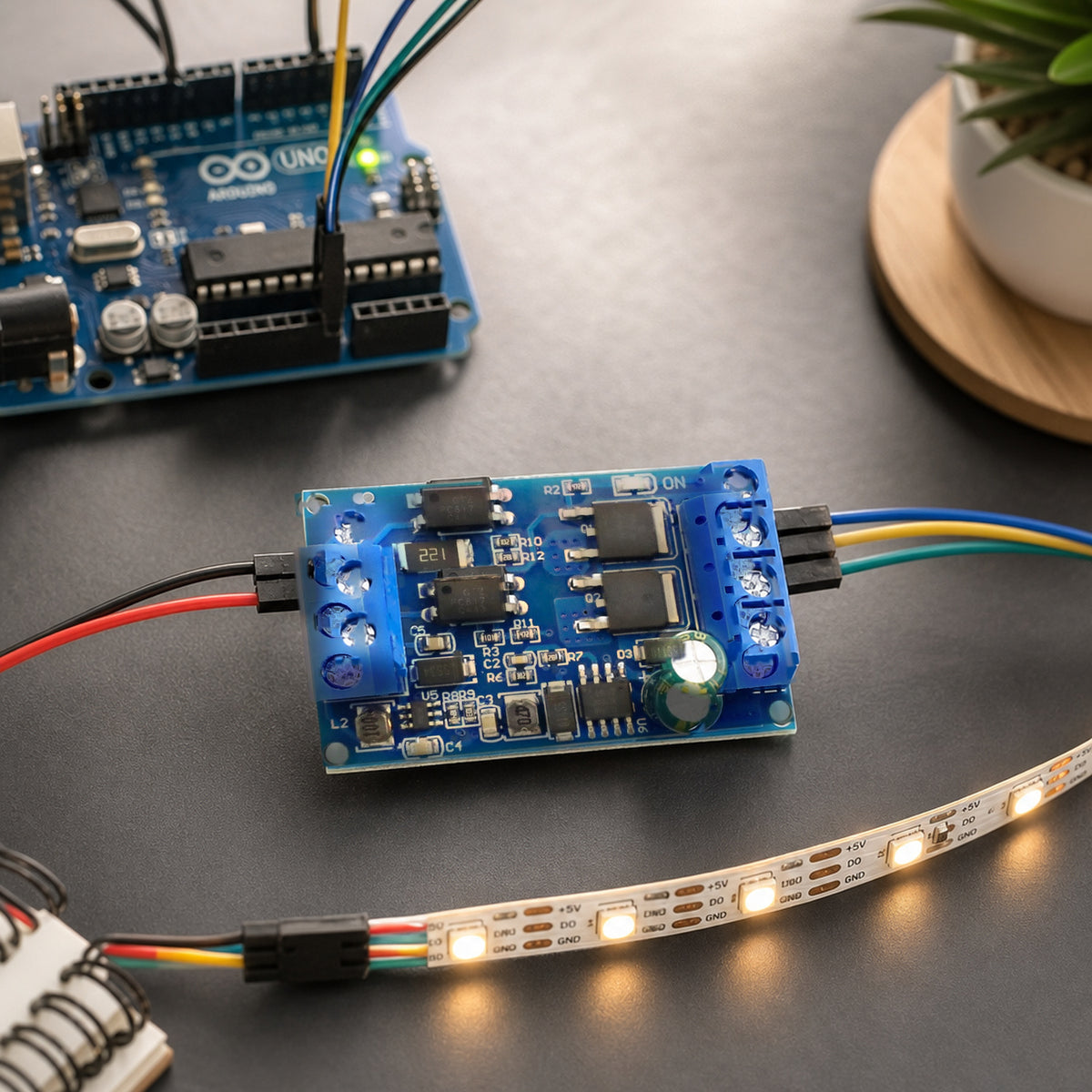 MOSFET PWM switch module – top-down on a dark desk: the module driving a warm-white LED strip
