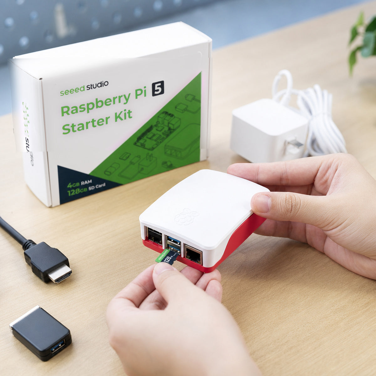 Raspberry Pi 5 starter kit – close-up of hands inserting a micro SD card into the cased Raspberry Pi 5 on a workbench