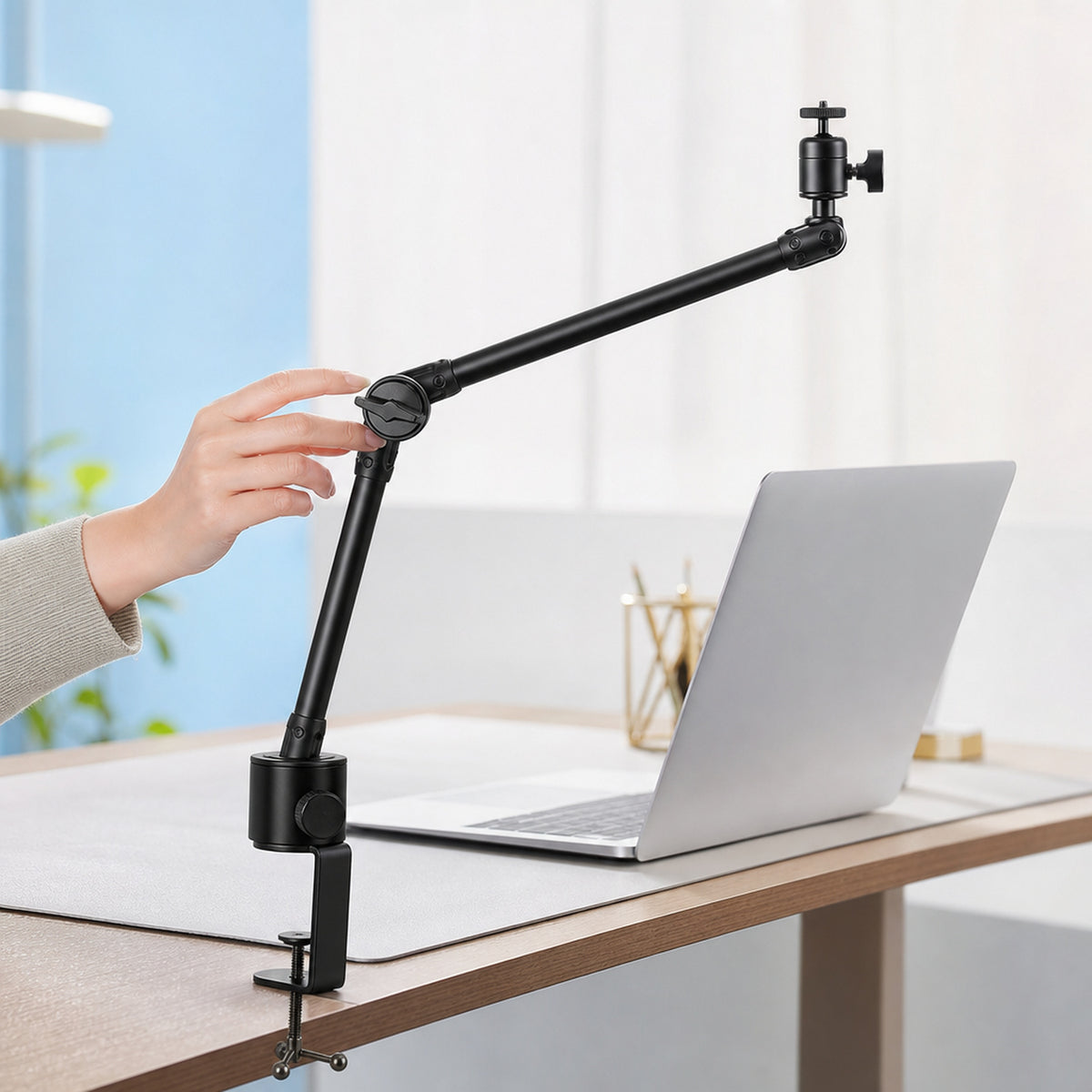 Overhead camera desk arm – side view of the arm extended over a workbench with a laptop