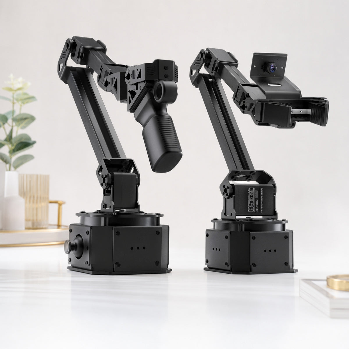 NexArm metal robot arm – product still life on a white background: leader and follower arm side by side