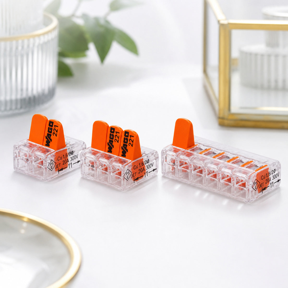 WAGO 221 lever wire connectors – product still life on a clean white background: a neat row of lever connectors with one lever lifted
